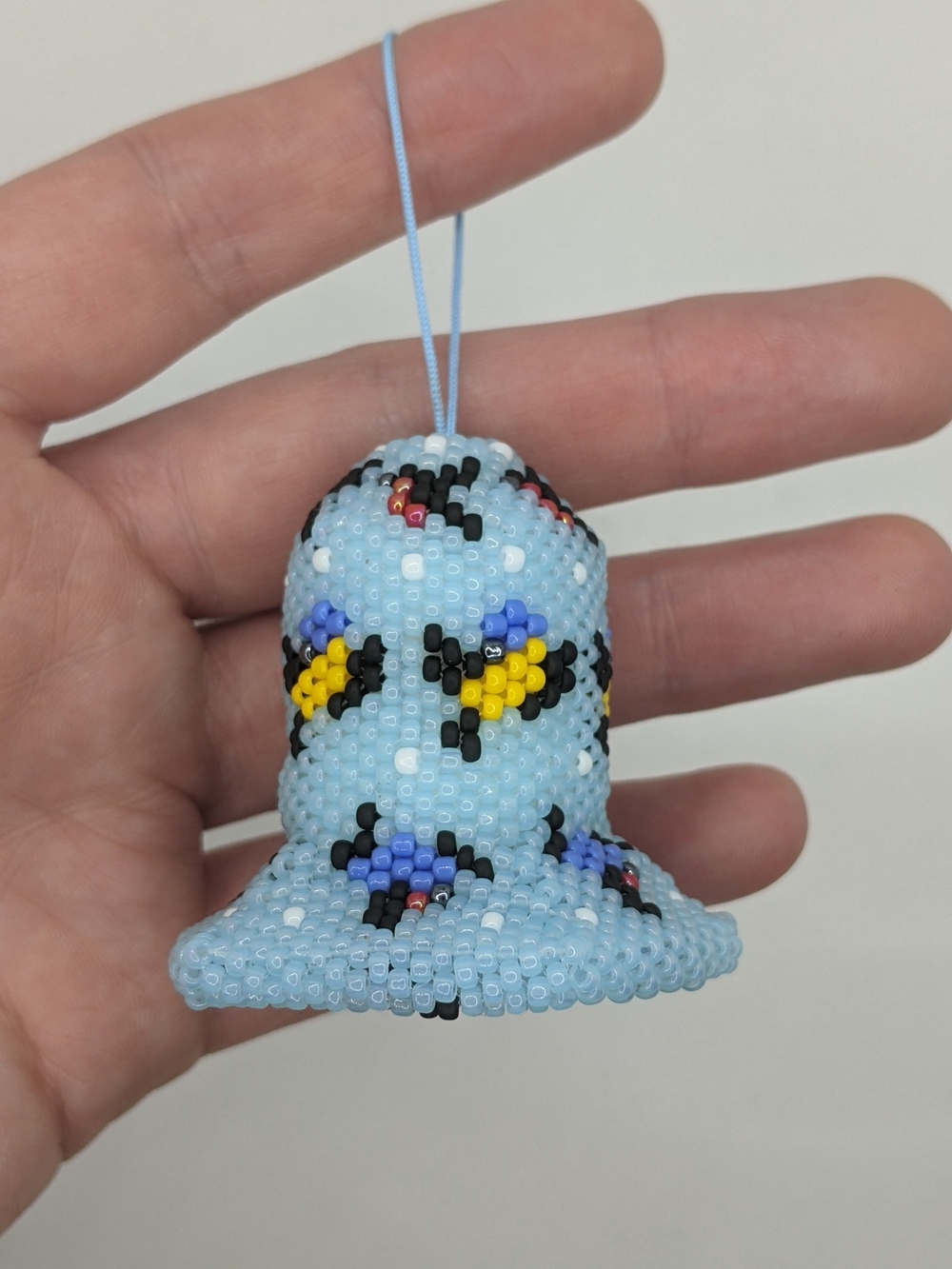 Handcrafted Light Blue Beaded Bell Ornament with Floral Accents